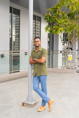 Wall Mural - Portrait of handsome young black man outdoors in city