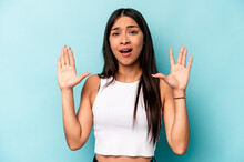 Young Hispanic Woman Isolated On Blue Background Screaming To The Sky, Looking Up, Frustrated.