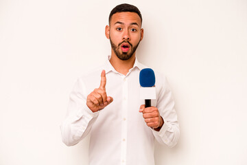 Wall Mural - Young hispanic TV presenter isolated on blue background having some great idea, concept of creativity.