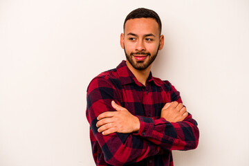 Wall Mural - Young hispanic man isolated on white background laughing and having fun.