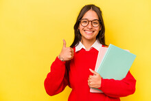 Young Student Hispanic Woman Isolated On Yellow Background Smiling And Raising Thumb Up