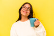 © Asier - Young hispanic woman holding a mug isolated on yellow background