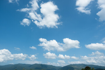 Wall Mural - the white clouds have a strange shape and moutain.the sky and the open space have mountains below.