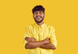 Portrait of funny young indian man isolated on yellow studio background look at camera laughing smiling. Happy biracial guy feel optimistic and joyful. Diversity and multicultural society.