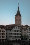 Fototapeta Miasto - St. Peter's Church in Zurich and its clock at sunset on a March day