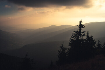 Fototapete - Landscape of warm light sun rays on sky through the clouds over the mountains in Czech republic, Jeseniky