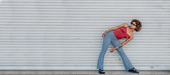 Wall Mural - urban african american girl posing or dancing in the street