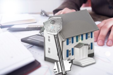 Sticker - Model houses and contract documents on the desk in the office, contract about mortgage and home insurance offers