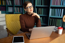 Financier Woman With Glasses Works Uses Computer In Office In Coworking Space