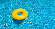 Yellow Ring Floating In Blue Swimming Pool. Inflatable Ring, Rest Concept