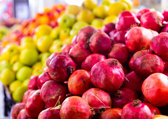 Wall Mural - Heap of fresh eco pomegranates for sale in market, background of pomegranate fruits