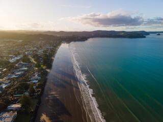 Wall Mural - Sunset along Orewa beach on New Zealand's Hibiscus coast