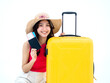 © tete_escape - Beautiful happy Asian woman in pink sleeveless shirt and beach hat smile and holding passport, flight ticket and yellow suitcase isolated on white background. Young traveler or tourist ready to trip.