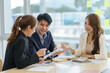 © amnaj - Asian business people planning analyze investment and marketing in office. Business meeting to brainstorm the new project and analysis data document.