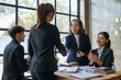 © amnaj - Happy young Asian business people shaking hands to congratulate success. Business executives handshake to congratulate the joint business agreement.