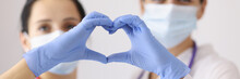 Physicians Forming Heart With Hands