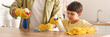 © Pixel-Shot - Father and little son cleaning table in kitchen