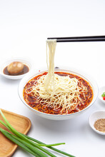 A Bowl Of Noodles Marinated Egg Shallot, Sesame Seeds With Chopsticks
