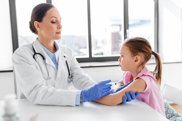 Sticker - medicine, healthcare and vaccination concept - female doctor or pediatrician with syringe making vaccine injection to little girl patient at clinic