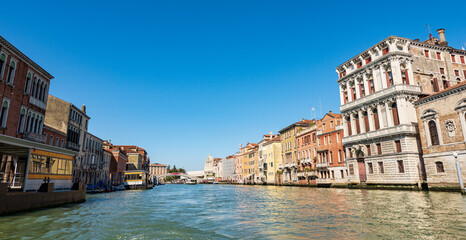 Venice cityscape and the Grand Canal (Canal Grande) with two ferry boats stations. UNESCO world heritage site, Venetian lagoon, Veneto, Italy, Europe.