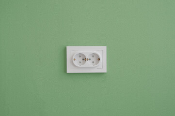 Wall Mural - Electrical outlet in the green wall background