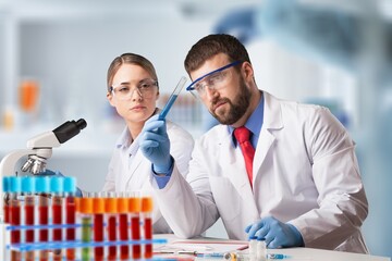 Wall Mural - Woman scientist working in lab. Research concept. Microscope at blood and chemical test sample