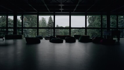 Modern empty hall interior with bag chairs sofa at panorama window background.