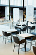 © Seventyfour - Minimal background image of minimal food court interior in black and white with tables and chairs in row, copy space