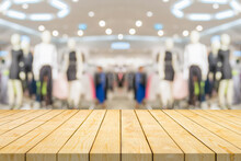 Empty Wood Table Top With Blur Clothing Boutique Display Interior Shopping Mall Background