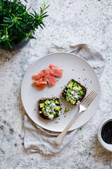 Wall Mural - Healthy breakfast with salmon and toasts with rye bread, avocado and blue cheese