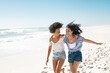 © Rido - Happy women friends running on summer beach with copy space