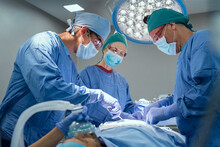 Team Of Surgeons Performing Operation At Hospital