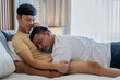© somchairakin - Cheerful Homosexual couple embracing, cuddling in the bed, gay couple LGBTQ, LGBTQ+, LGBT couple lovers in bedroom. Concept of LGBTQ relationship.
