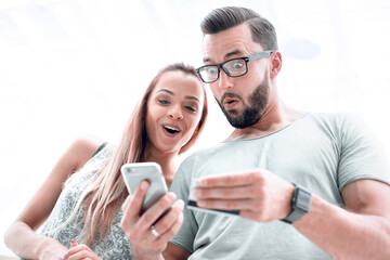 Young couple doing online shopping with smartphone