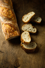 Poster - Traditional homemade baguette bread on a wooden table