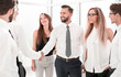 © ASDF - handshake of young business partners in the office.