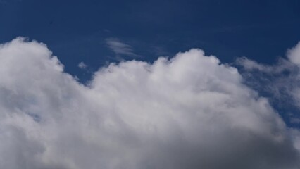 Wall Mural - cloud and blue sky timelape of dramatic fast moving white clouds on sunny blue sky