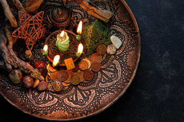 Wall Mural - Witch altar with candles, old coins, stone runes, minerals, pentacle on dark table background. Magic for attracting money, wealth. witchcraft money esoteric ritual. occultism concept. top view