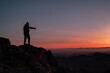 © dalia - silhouette of a person on a mountain top during sunrise