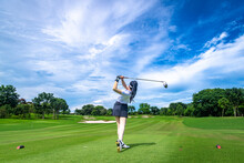 Professional Woman Golfer Teeing Golf In Golf Tournament Competition At Golf Course For Winner	
