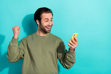 Poster - Photo of hooray brunet millennial guy look telephone wear khaki sweatshirt isolated on teal color background