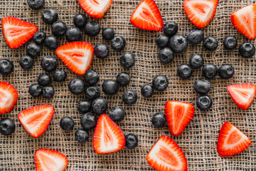 Wall Mural - Top view of fresh berries on sackcloth.