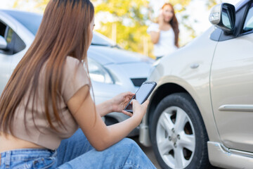 Wall Mural - Two drivers check for damage after a car accident before taking pictures and sending insurance. Online car accident insurance claim idea after submitting photos and evidence to an insurance company.