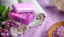 Spa And Bath Accessories In Purple Tones. Soap, Towels, Sea Salt. A Branch Of Lilac.