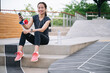 Portrait beautiful Asia woman smart phone after exercise jogging	