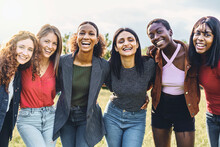 Cheerful Multi-ethnic Group Of Young Women Hugging Arms On Shoulders Outdoors Laughing, Smiling And Looking At The Camera - Youth Culture Lifestyle Concept - Only Women