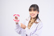 Young female dentist smiling over white background studio
