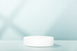 © Natalia Klenova - Abstract empty white podium with geometric shadows on blue background. Mock up stand for product presentation.  Minimal concept