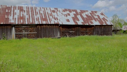 Wall Mural - 4k video of old wooden barn on polish countryside, Mazowsze region of Poland