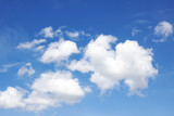 Fototapeta Na sufit - Clouds in a bright blue sky in sunlight